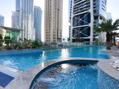 a large swimming pool in a city with tall buildings at Next To Metro Unique 2bed Apt Wlarge Balcony in Dubai