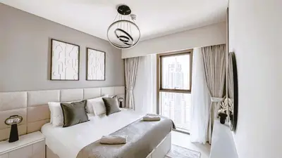 a bedroom with a large white bed and a window at Burj Crown Luxurious 2Bedroom Balcony in Dubai