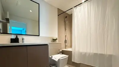 a bathroom with a toilet and a sink and a mirror at Burj Crown Luxurious 2Bedroom Balcony in Dubai