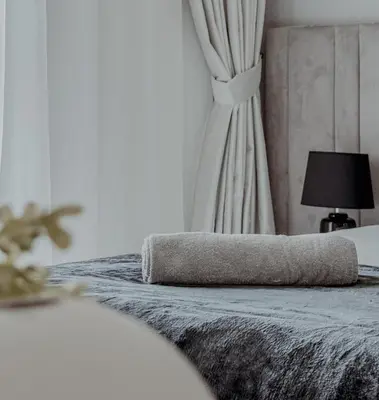 a bedroom with a bed with a curtain and a lamp at Burj Crown Luxurious 2Bedroom Balcony in Dubai