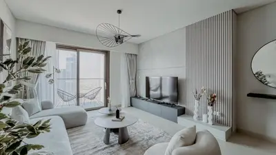 a living room with a couch and a tv at Burj Crown Luxurious 2Bedroom Balcony in Dubai