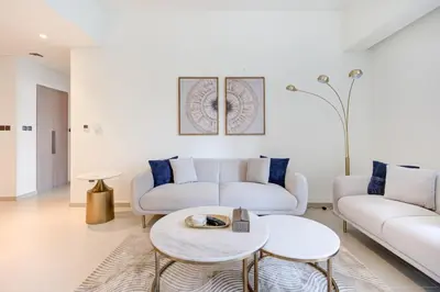 a living room with two couches and a table at Brand New Luxurious 2BR ACT Towers Downtown in Dubai