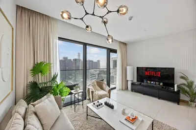 a living room with a couch and a tv at Hidden Gem, Waterfront Escape With Harbor View in Dubai