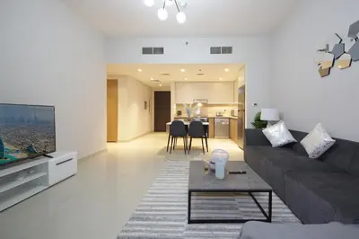 a living room with a couch and a table at Elegant Waterfront 1BHK in Dubai Creek Harbour in Dubai