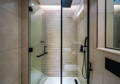 a shower with a glass door in a bathroom at HAVN - Studio in MYKA, Near Meaisem City Center in Dubai