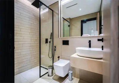 a bathroom with a sink and a toilet and a shower at HAVN - Studio in MYKA, Near Meaisem City Center in Dubai