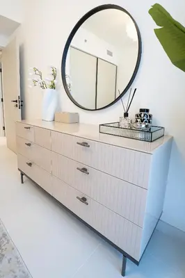 a mirror on top of a dresser in a room at Veluxa - Luxe 2Bed with Private Beach in Dubai