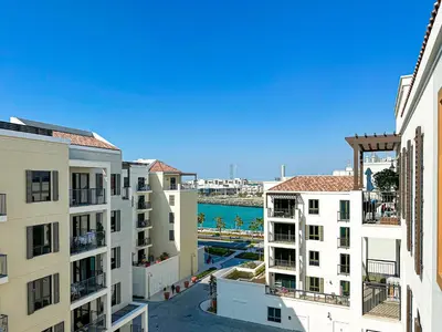 a view of the ocean from an apartment building at HiGuests - Coastal Chic Luxurious Retreat at Port de la Mer in Dubai