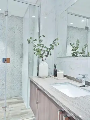 a white bathroom with a sink and a mirror at Vacay Lettings 1 bed Business home in J One Tower Business bay in Dubai