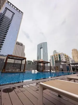 a swimming pool on the roof of a building at Naseem - Studio One Tower in Dubai