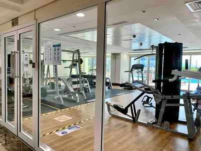 a gym with several treadmills and elliptical machines at Jlt Spacious Corner Duplex Loft Panoramic Views in Dubai