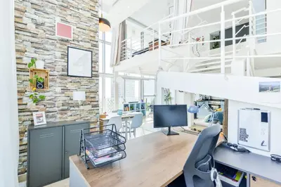an office with a desk with a computer and a chair at Jlt Spacious Corner Duplex Loft Panoramic Views in Dubai