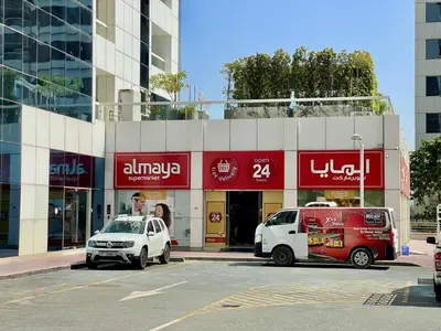 a car and a van parked in front of a building at Spacious Jlt High Floor Studio Wstunning Views in Dubai