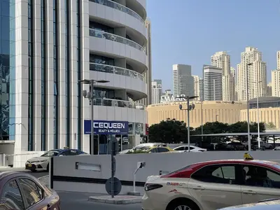 a parking lot with cars parked in front of a building at Spacious Jlt High Floor Studio Wstunning Views in Dubai