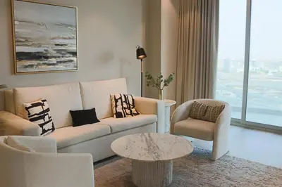 a living room with a couch and a table at Casa Royale Vacation Home - Dubai Marina in Dubai