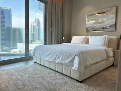 a bedroom with a large bed and a large window at Casa Royale Vacation Home - Dubai Marina in Dubai