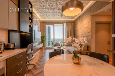 a kitchen and living room with a table and chairs at Forte Tower by Emaar, Downtown Dubai in Dubai