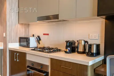 a kitchen with a stove and a microwave at Forte Tower by Emaar, Downtown Dubai in Dubai