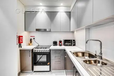 a kitchen with a sink and a stove at Forte Tower by Emaar, Downtown Dubai in Dubai