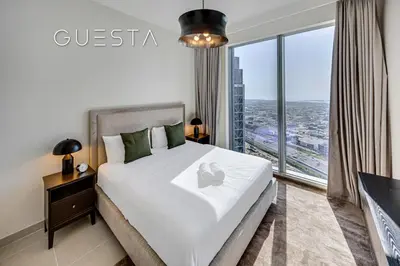a bedroom with a large bed and a large window at Forte Tower by Emaar, Downtown Dubai in Dubai