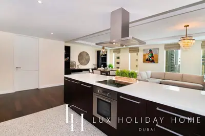 a kitchen with a large island in a living room at LUX The Elegant DIFC Suite 2 in Dubai