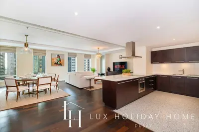 a kitchen and living room with a table and a kitchen and a dining room at LUX The Elegant DIFC Suite 2 in Dubai