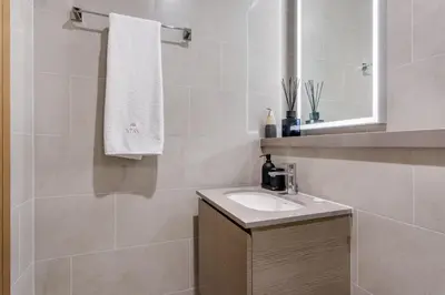 a bathroom with a sink and a mirror at STAY BY LATINEM Luxury 2BR Holiday Home W3104 near Burj Khalifa in Dubai