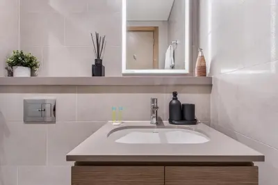 a bathroom with a sink and a mirror at STAY BY LATINEM Luxury 2BR Holiday Home W3104 near Burj Khalifa in Dubai