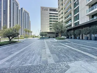 an empty street in a city with tall buildings at Lux 1BR Apartment with Amazing view in Palace Residences Creek Harbor in Dubai