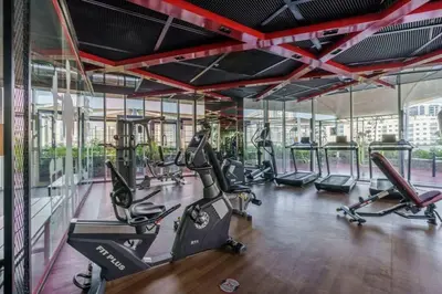a gym with treadmills and ellipticals in a building at Dubai Sleek & Cozy Space in Dubai