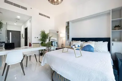 a bedroom with a large bed and a desk in it at Dubai Sleek & Cozy Space in Dubai
