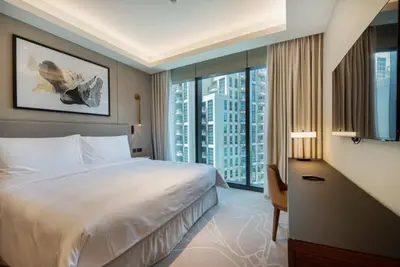 a hotel room with a bed and a large window at Luxurious stay in Downtown Dubai in Dubai