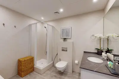 a bathroom with a toilet and a shower and a sink at MAG 218 Tower - Elegant One Bedroom in Dubai