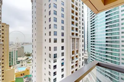 a view from the balcony of a tall white building at Vacationer I Premium 1 Bed I Steps to JBR Beach & Nightlife I Bahar 6 Tower in Dubai