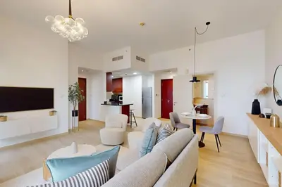a living room with a couch and a table at Vacationer I Premium 1 Bed I Steps to JBR Beach & Nightlife I Bahar 6 Tower in Dubai