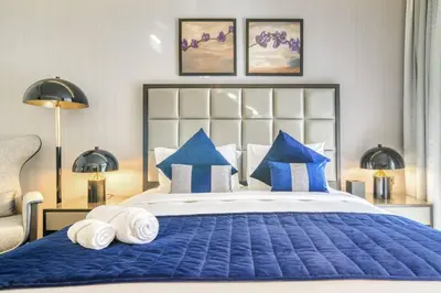 a bedroom with a large blue bed with blue pillows at Dazzling Studio Apartment in Business Bay l City View in Dubai