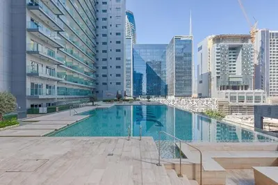 a swimming pool in a city with tall buildings at Dazzling Studio Apartment in Business Bay l City View in Dubai