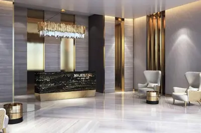 a lobby of a hotel with chairs and a chandelier at Dazzling Studio Apartment in Business Bay l City View in Dubai
