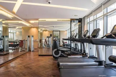a gym with treadmills and ellipticals in a building at Dazzling Studio Apartment in Business Bay l City View in Dubai