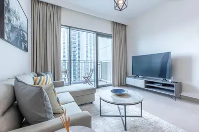 a living room with a couch and a flat screen tv at 1BR Apartment in Park Heights 2 Dubai Hills in Dubai