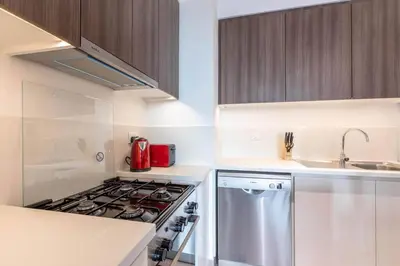 a kitchen with a stove and a sink at 1BR Apartment in Park Heights 2 Dubai Hills in Dubai
