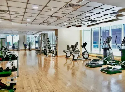 a gym with treadmills and exercise equipment in a room at Spacious 1BR in the iconic Torch Tower, Dubai Marina - Allsopp&Allsopp in Dubai