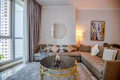 a living room with a couch and a table at Spacious 1BR in the iconic Torch Tower, Dubai Marina - Allsopp&Allsopp in Dubai