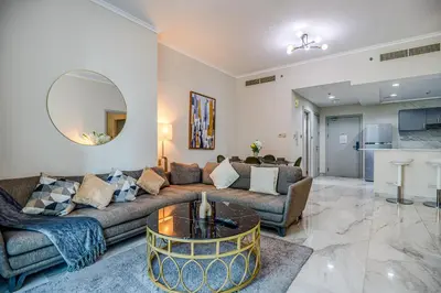 a living room with a couch and a table at Spacious 1BR in the iconic Torch Tower, Dubai Marina - Allsopp&Allsopp in Dubai