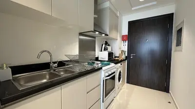 a kitchen with a sink and a counter top at EasyGo - Carson Tower C Damac Hills Studio in Dubai