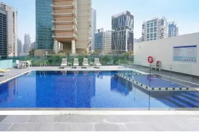 a large swimming pool on top of a building at Luxury Studio Apartment By DownTown in Dubai
