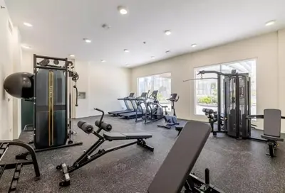 a gym with a bunch of treadmills and machines at Luxury Studio Apartment By DownTown in Dubai