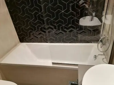 a bathroom with a shower with a black and white tile at Luxury Studio Apartment By DownTown in Dubai