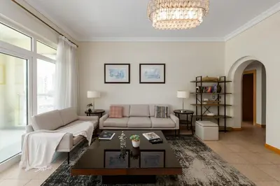 a living room with a couch and a table at Shoreline 7, Palm Jumeirah - Mint Stay in Dubai