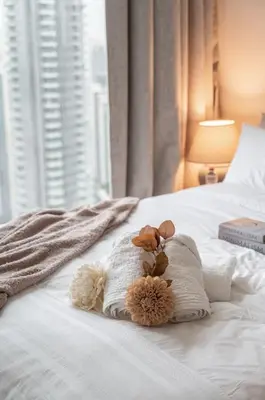 a stuffed animal sitting on top of a bed at 4BR - Burj and Fountain View - Opposite Dubai Mall in Dubai